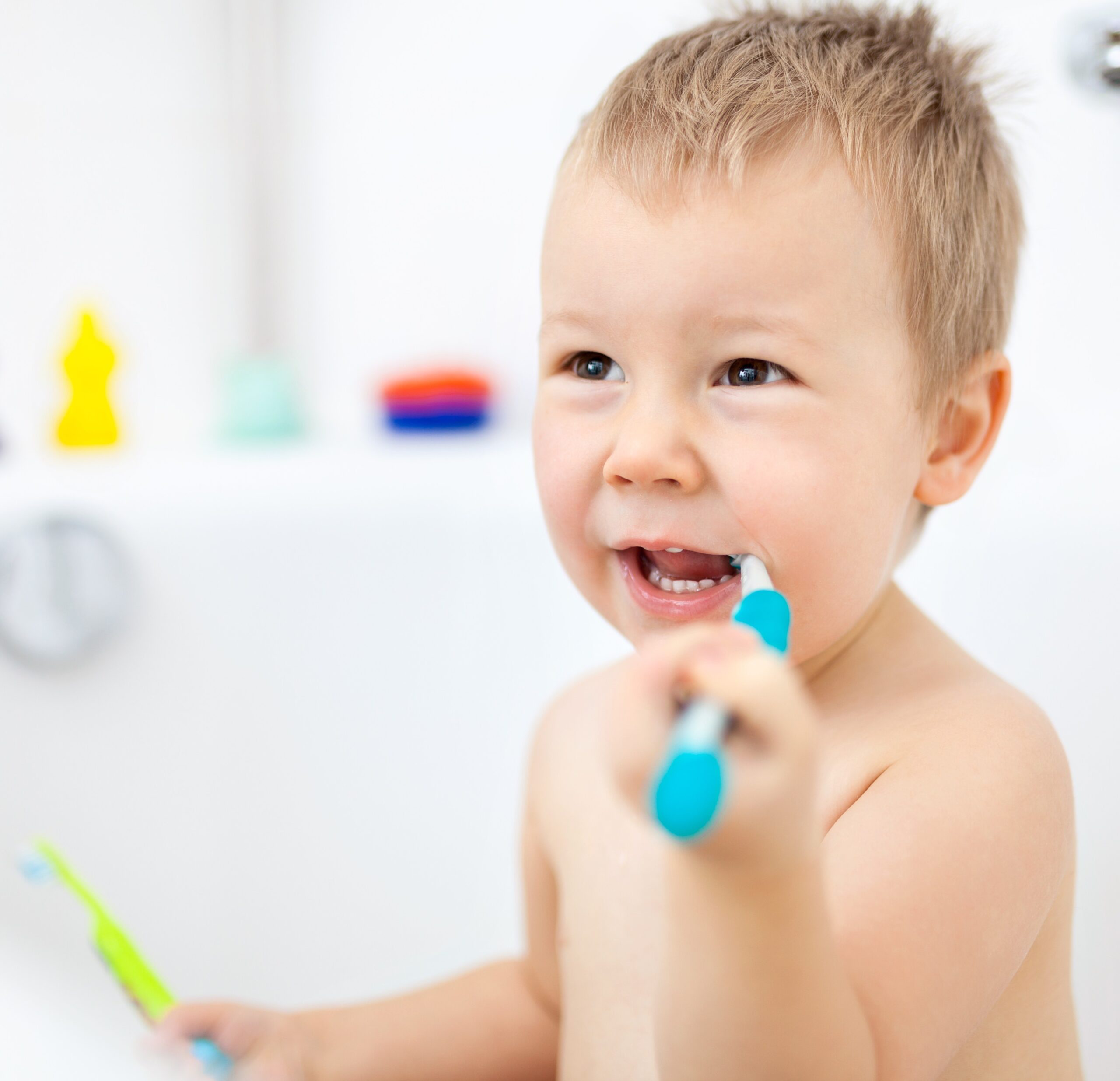 a smiling kid holding a brush