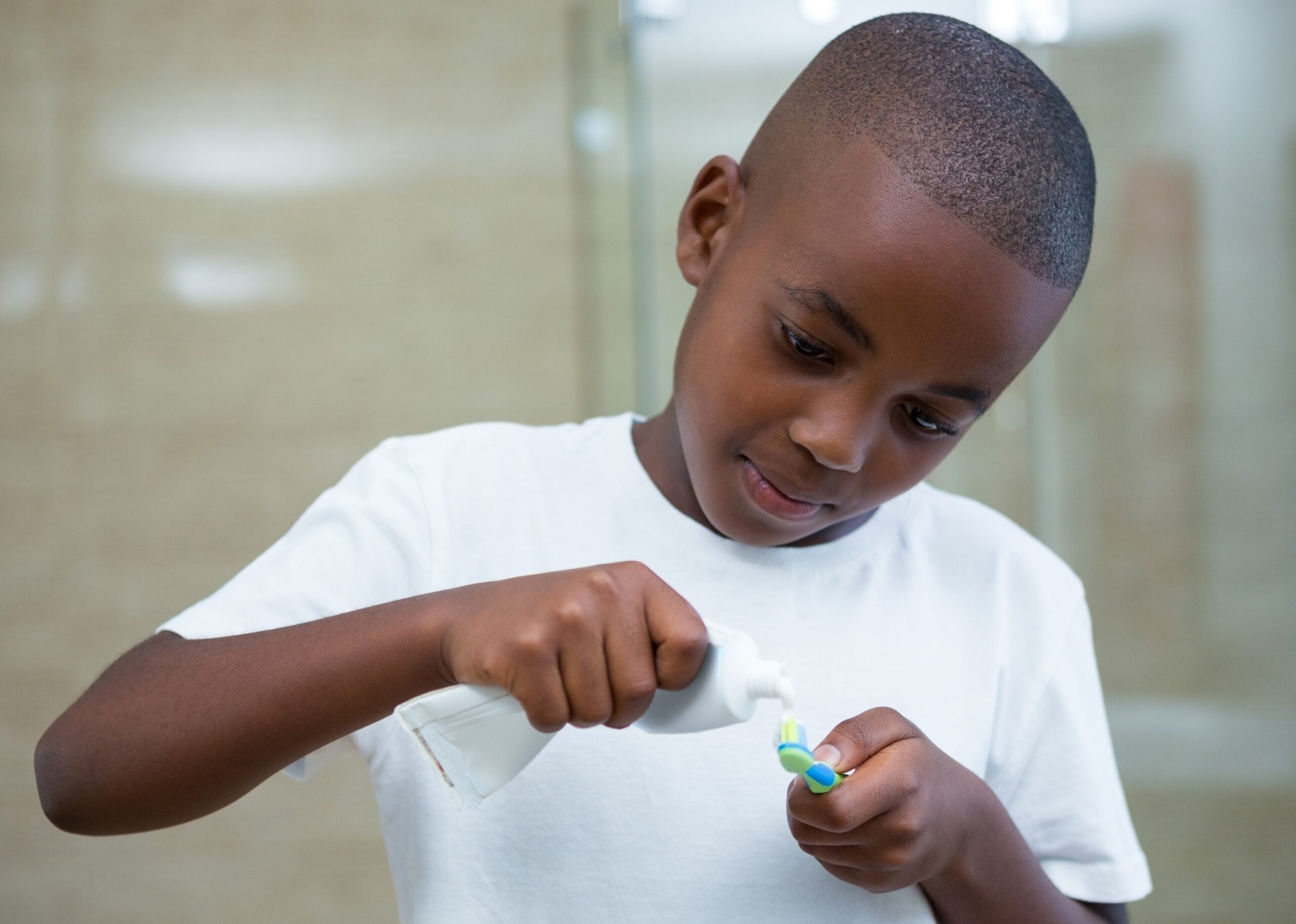 a kid of colour preparing for his brushing