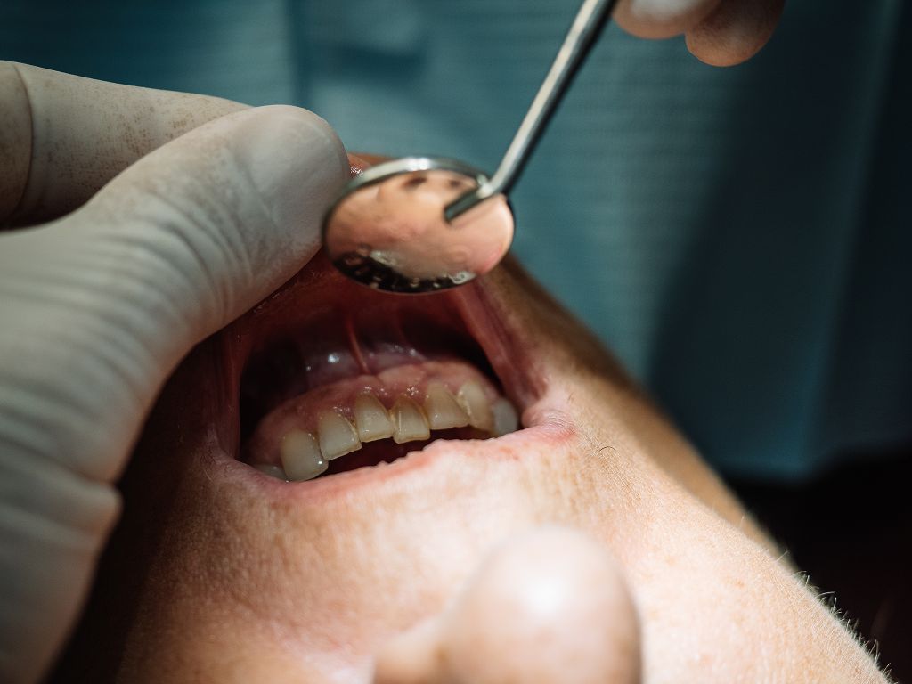 dentist checking a patients mouth for periodontal disease