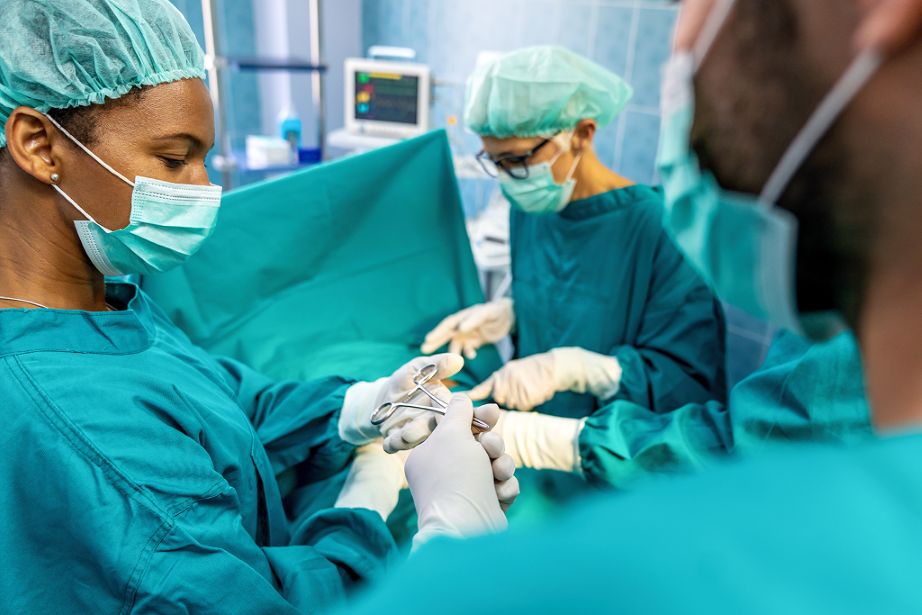 group of surgeons operating