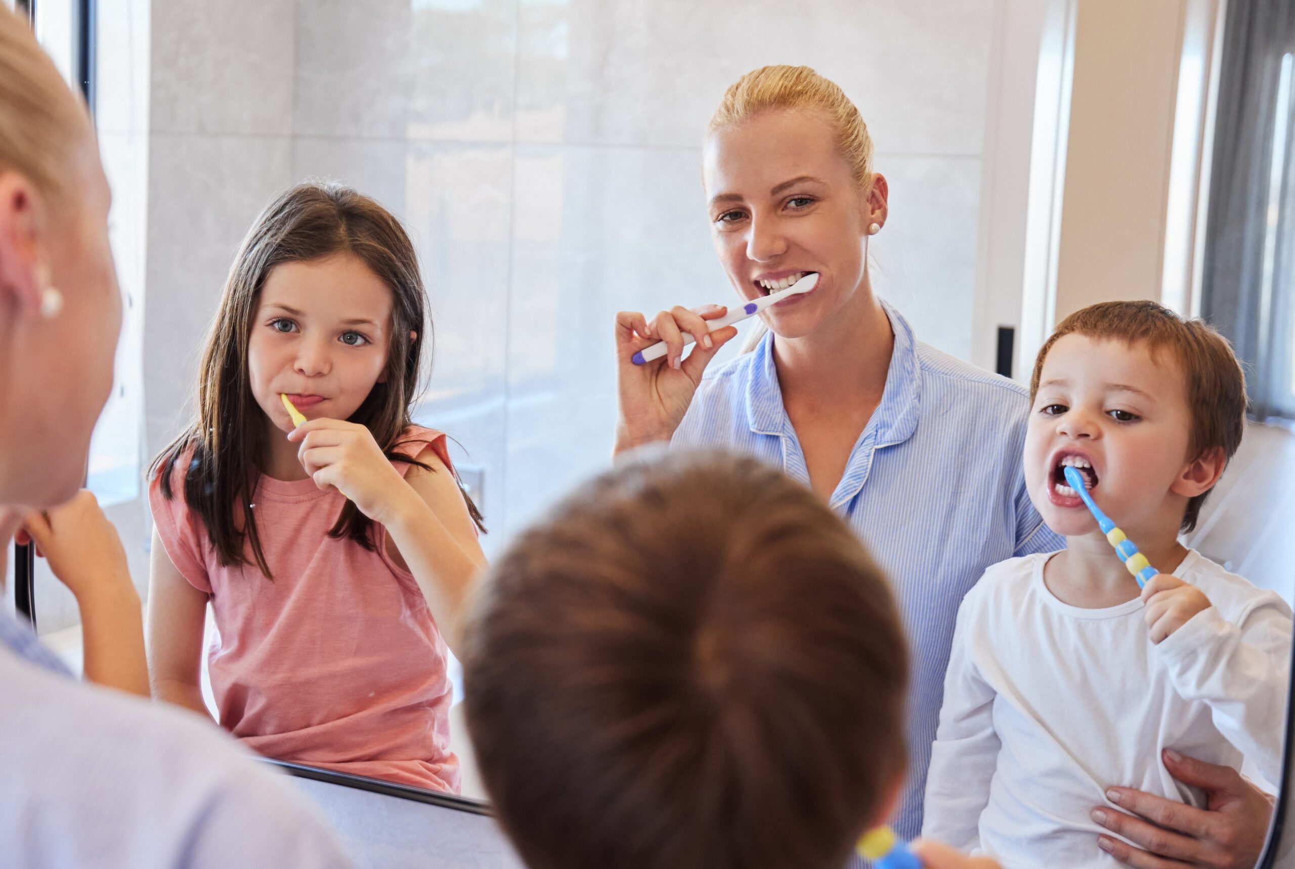 Mother with their kids happily brushing